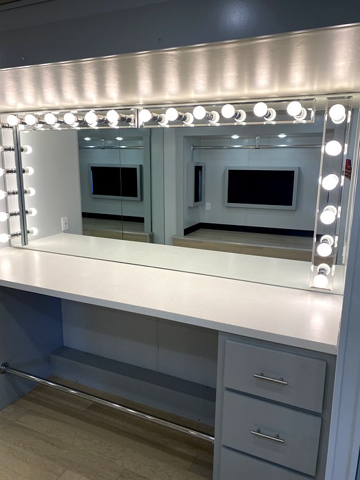 Hollywood vanity with globe lights in makeup trailer